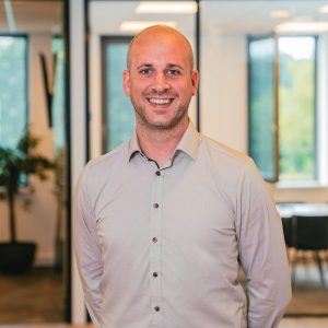 Man in office posing for camera